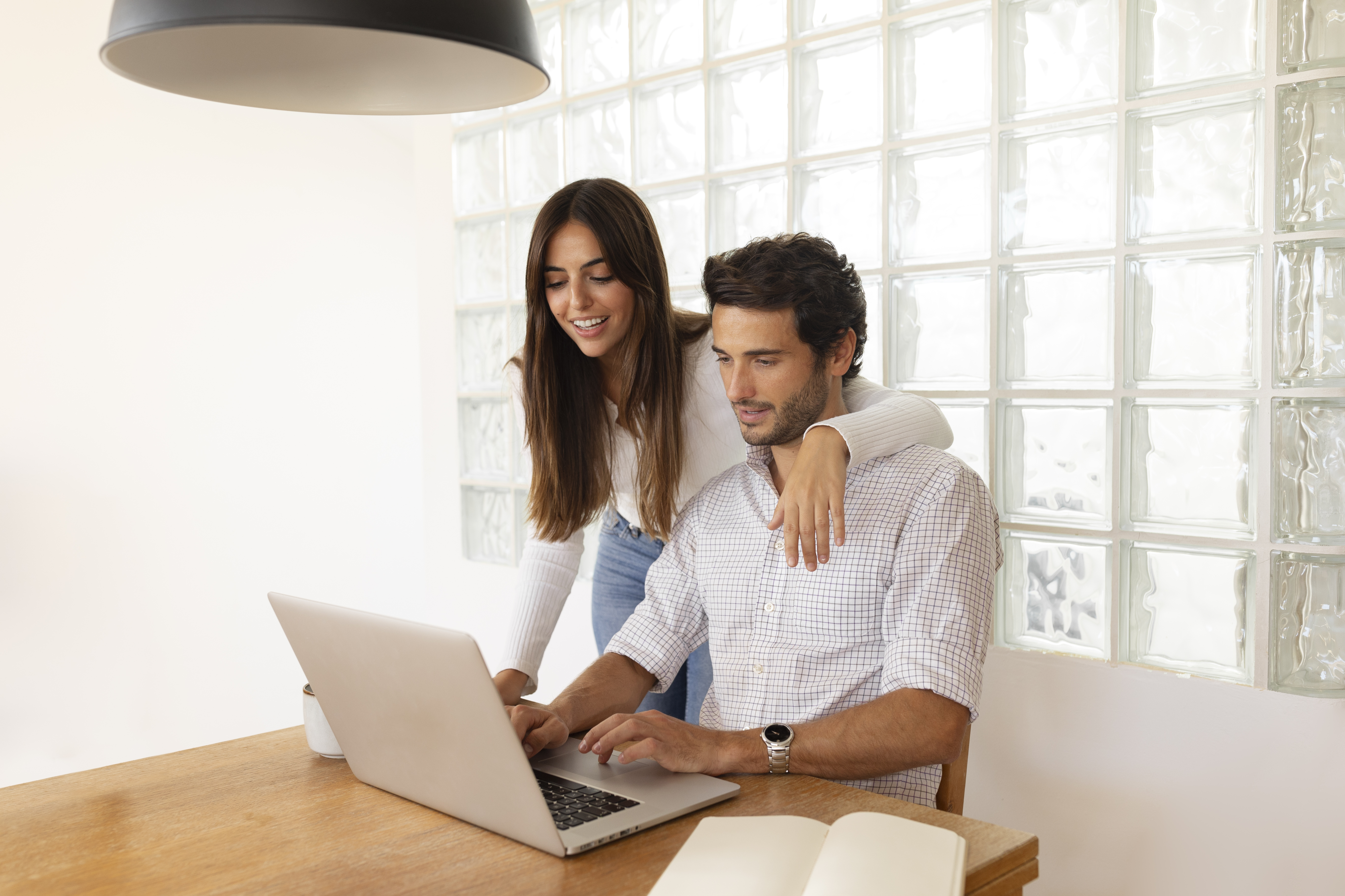 A man at his home office using a tablet to work through an online application