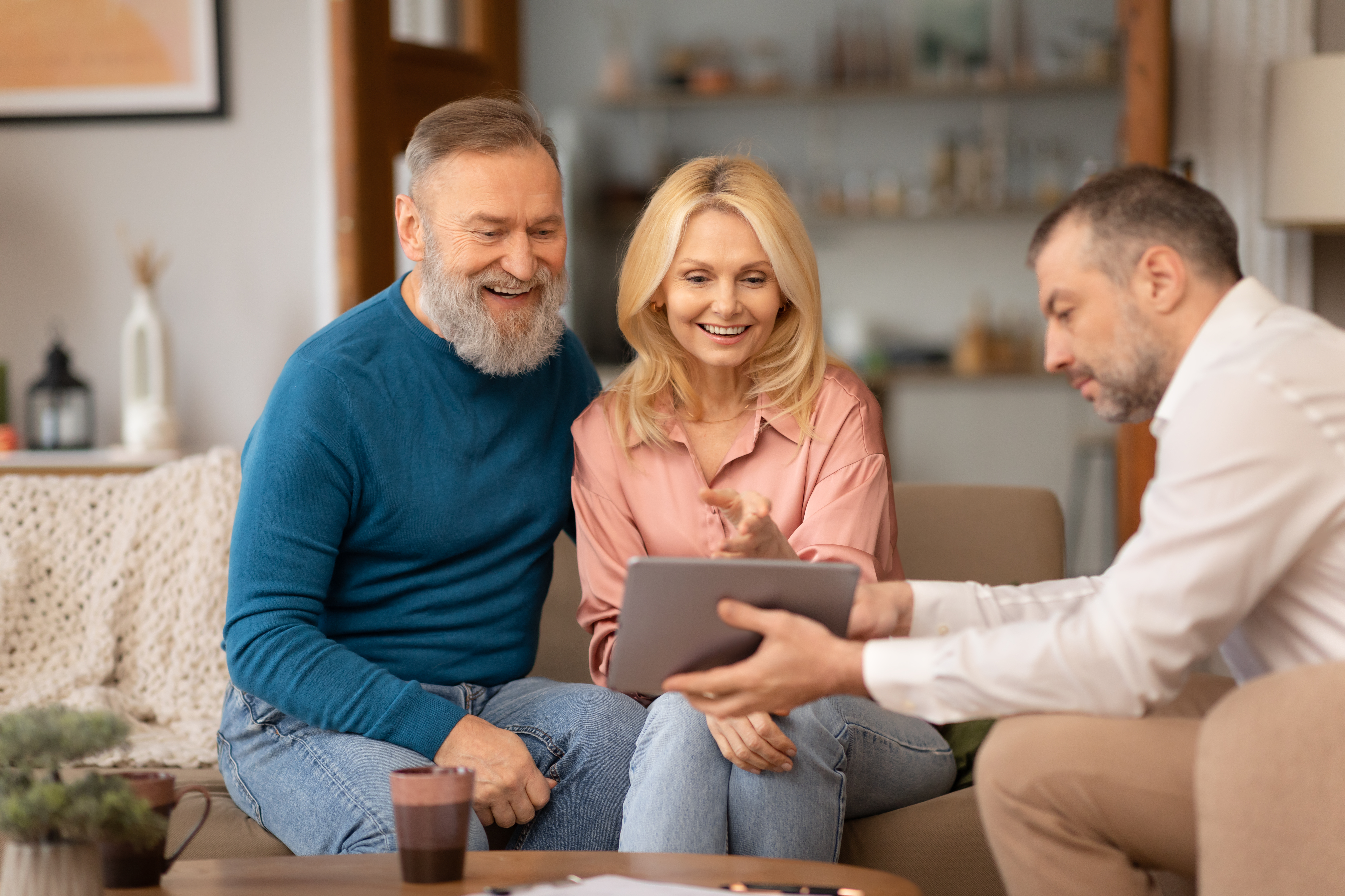 Senior Florida couple reviewing their affordable Marketplace plan on a tablet with a licensed local advisor