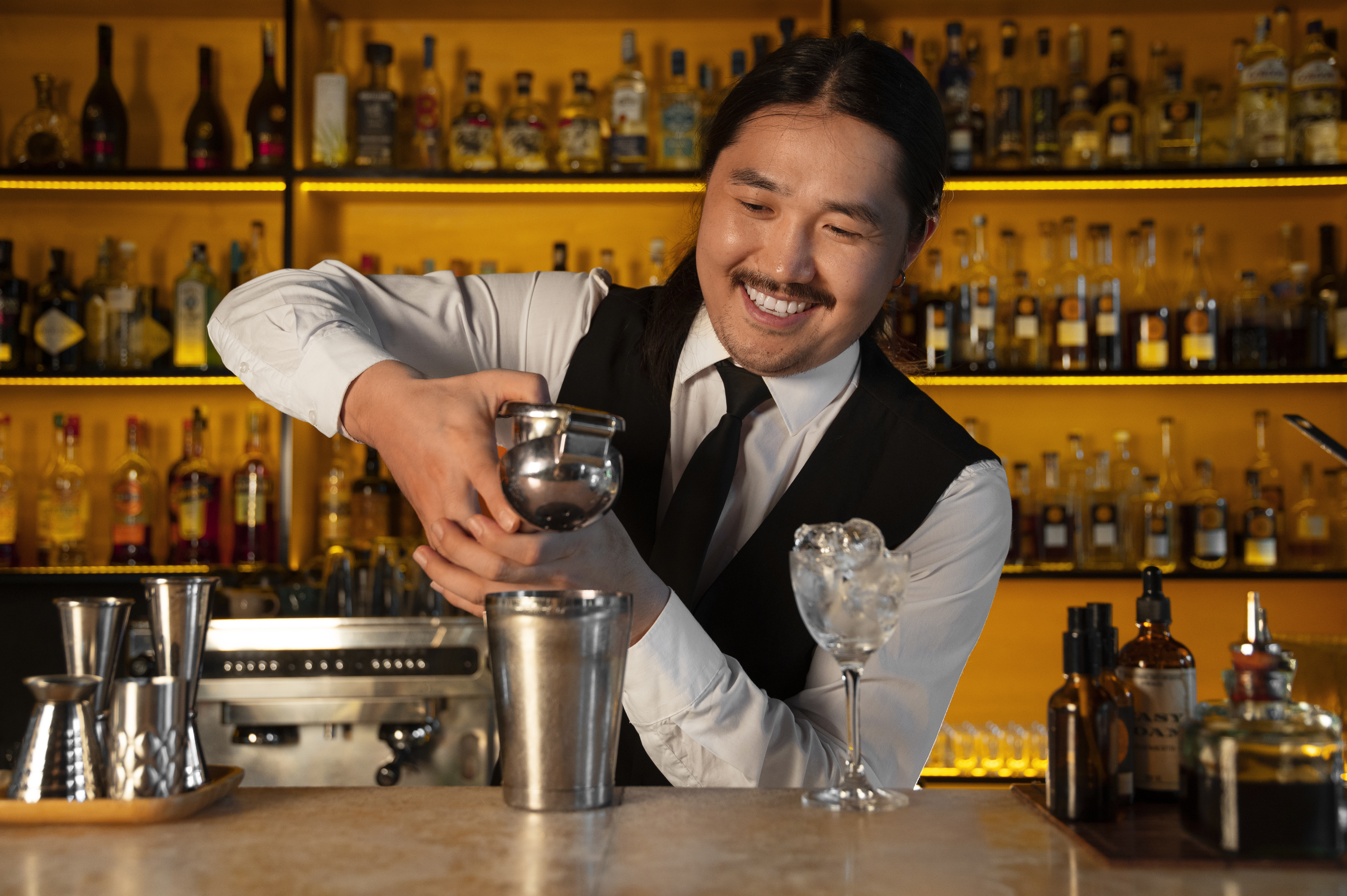 Florida bartender shaking a cocktail at a bar counter